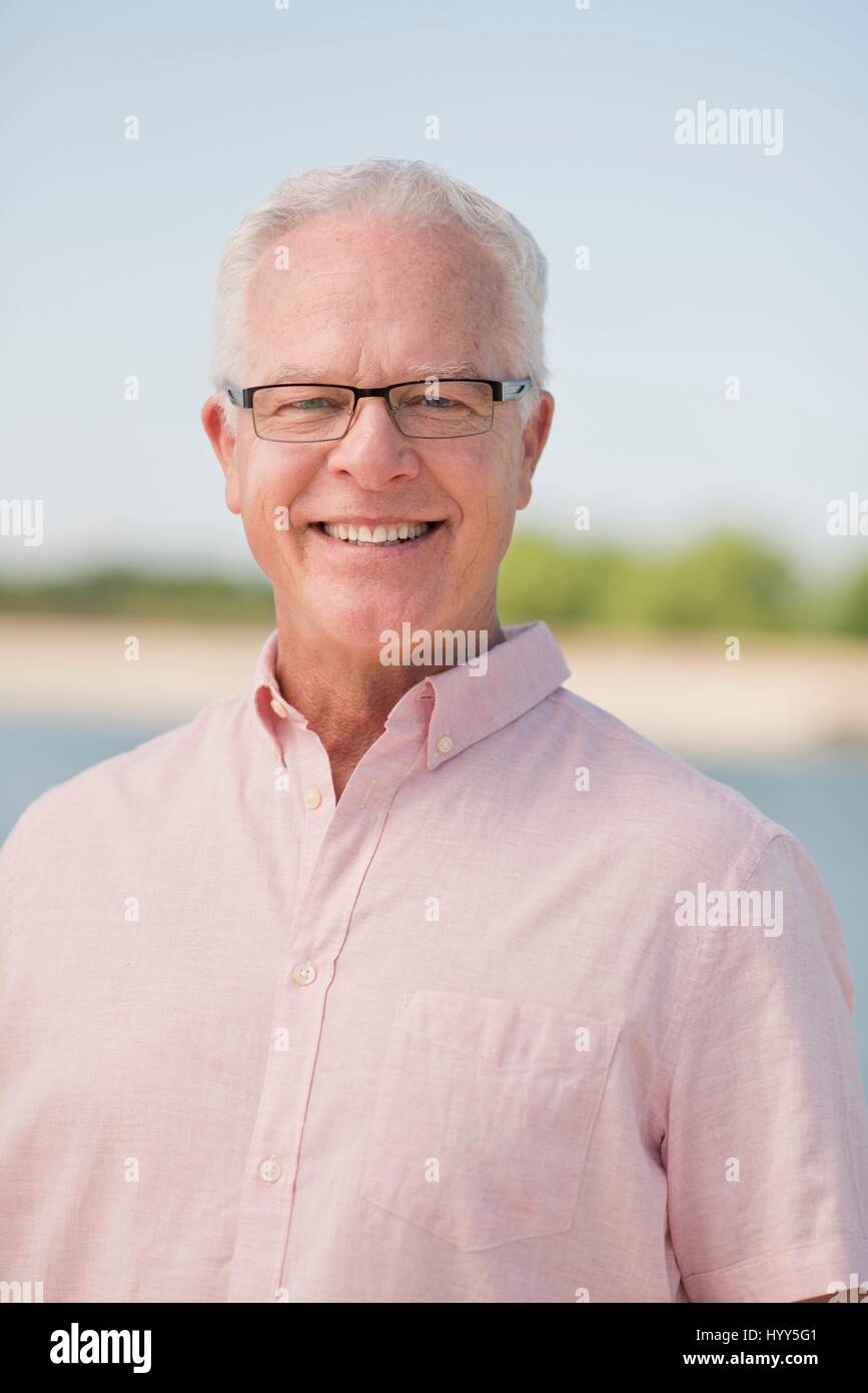 Senior man wearing glasses outdoors, portrait. Stock Photo