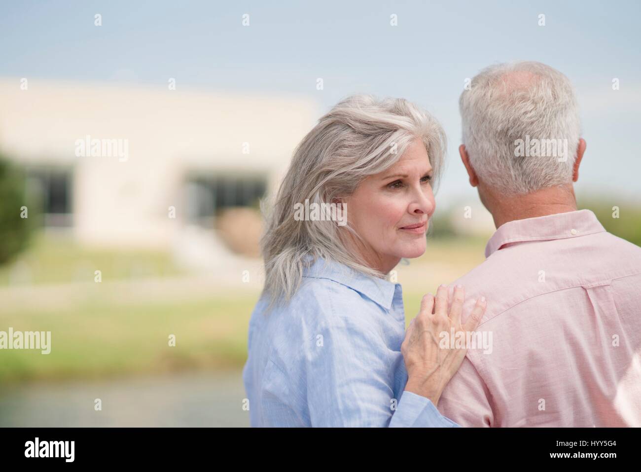 Senior woman with hand on man's shoulder. Stock Photo