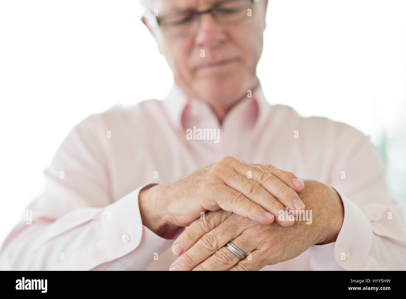 Senior man rubbing painful hand. Stock Photo