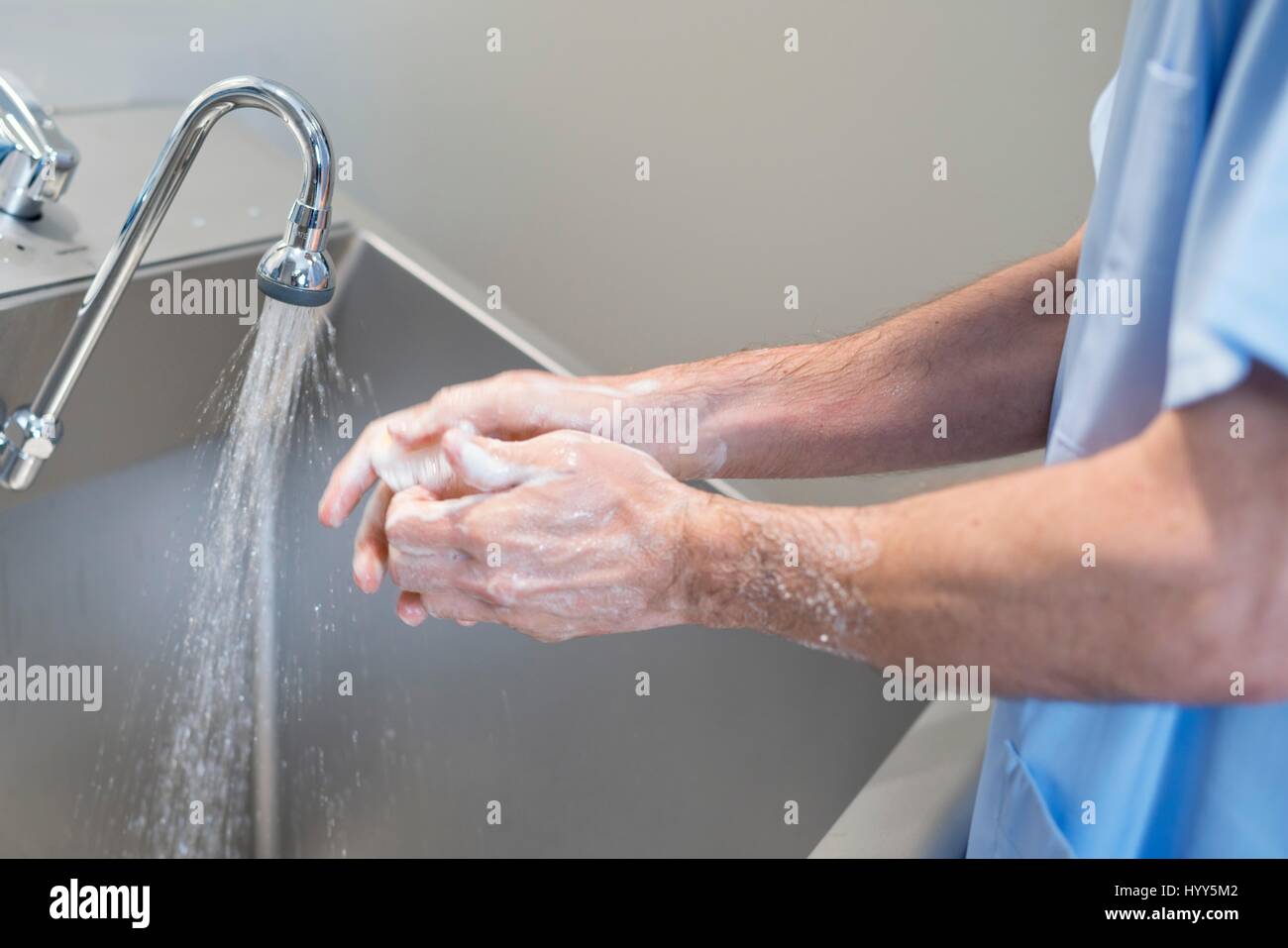 Doctor cleaning hands with soap and water in hospital. Stock Photo
