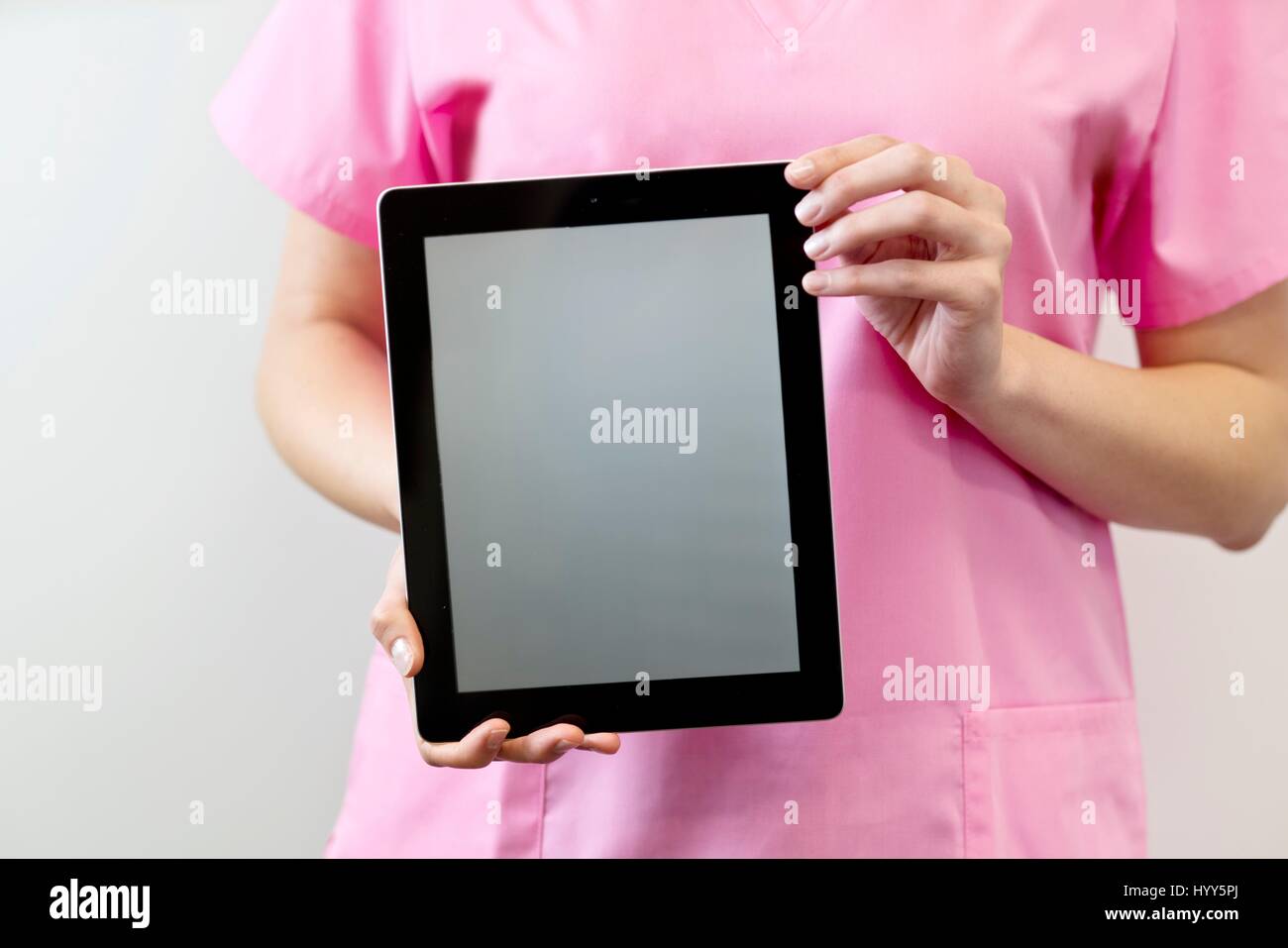 Female nurse holding digital tablet. Stock Photo