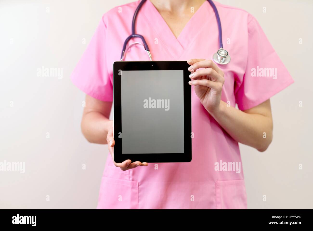 Female nurse holding digital tablet. Stock Photo