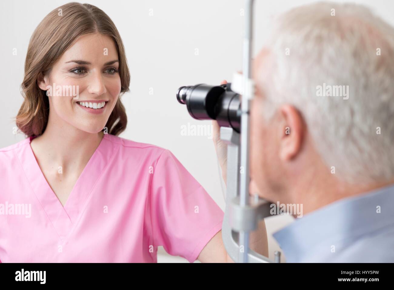 Female optician testing senior man's eyesight Stock Photo Alamy
