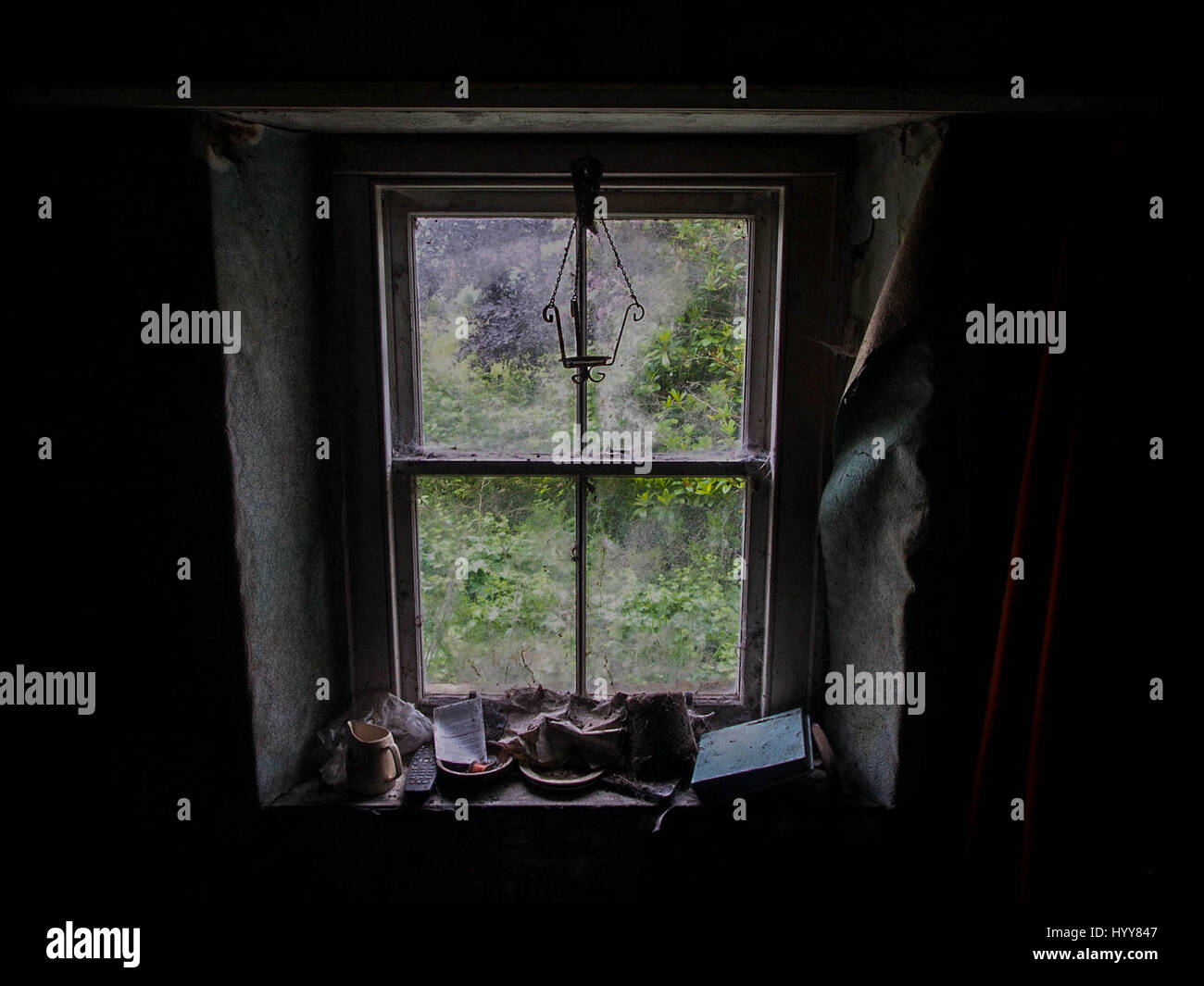 SCOTLAND: EERIE images reveal the decaying remains of a once idyllic countryside cottage nestled deep in the Scottish countryside since it was left empty more than ten-years-ago. The series of pictures show a moss ridden sink piled high with dishes, peeling wallpaper and paintings that have been left strewn across the floor. One image even shows a Rayburn cooker with pans left on the stove and another shows a holiday souvenir left on the windowsill. The spooky shots were taken in Ardnamurchan, Scotland by an urban explorer known only as The Forgotten Scotland. To take the pictures he used an O Stock Photo