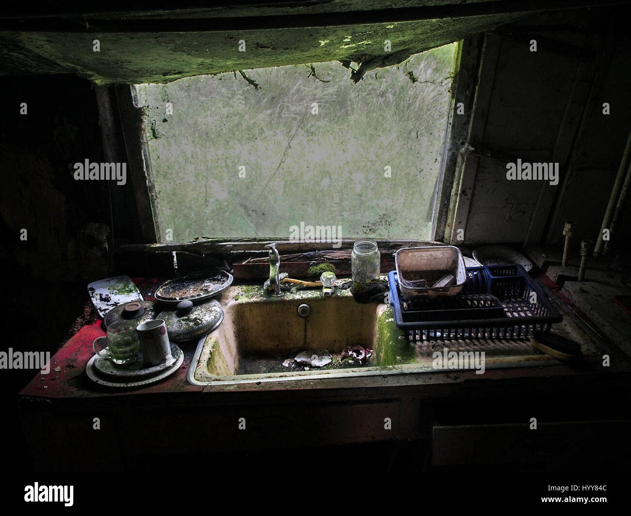SCOTLAND: EERIE images reveal the decaying remains of a once idyllic countryside cottage nestled deep in the Scottish countryside since it was left empty more than ten-years-ago. The series of pictures show a moss ridden sink piled high with dishes, peeling wallpaper and paintings that have been left strewn across the floor. One image even shows a Rayburn cooker with pans left on the stove and another shows a holiday souvenir left on the windowsill. The spooky shots were taken in Ardnamurchan, Scotland by an urban explorer known only as The Forgotten Scotland. To take the pictures he used an O Stock Photo