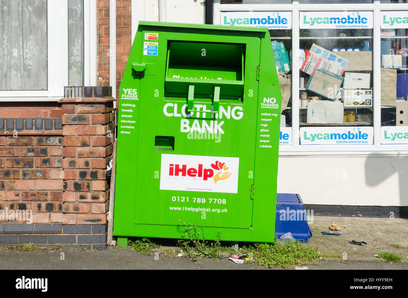 Bright green iHelp clothing bank charity recycling bin Stock Photo Alamy