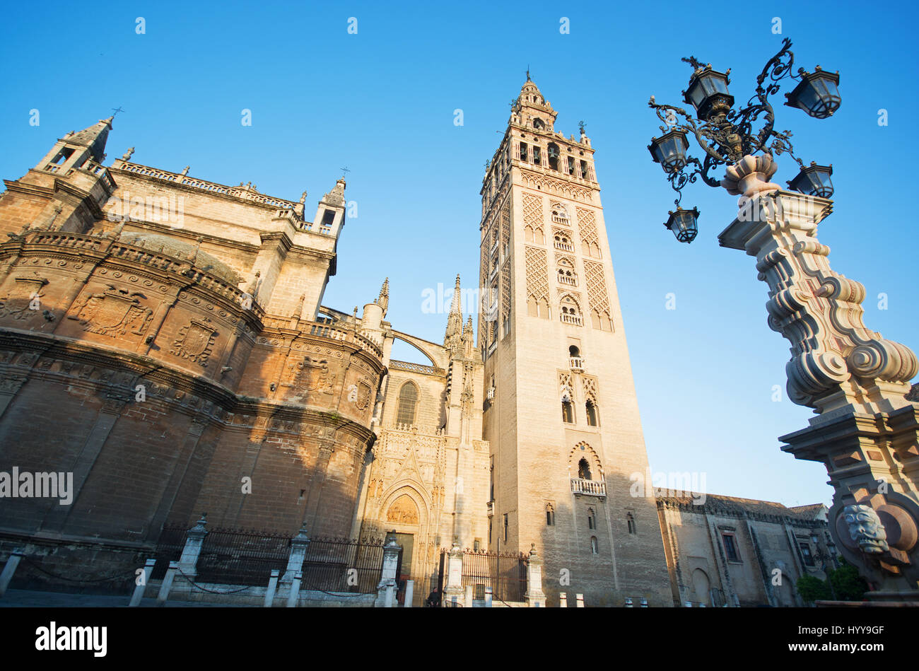 SEVILLE, ANDALUCIA, SPAIN. A low-angle view of Seville Cathedral and its bell tower known as la Giralda, formerly the minaret of Seville's mosque. Stock Photo
