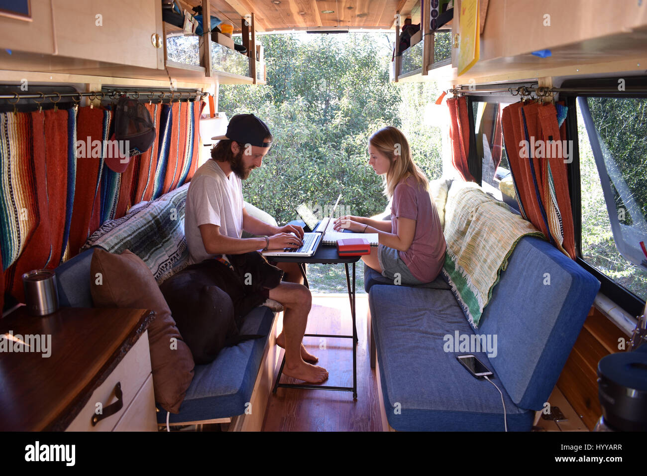 MEET the couple who shunned traditional office jobs and spent $5,000 converting their Dodge Sprinter van into a home to live life on the road with their beloved pet dog. The series of envy inducing pictures and video show Pete Thuli (24) and Taylor Bucher (23) also known as Always the Road from Wisconsin, USA enjoying life on the road as they travel around the states of America with their American Staffordshire Terrier, Snoop. Other shots show how the couple worked for four months whilst both holding down full time jobs to refurbish the van’s shell into a fully functional home complete with ki Stock Photo