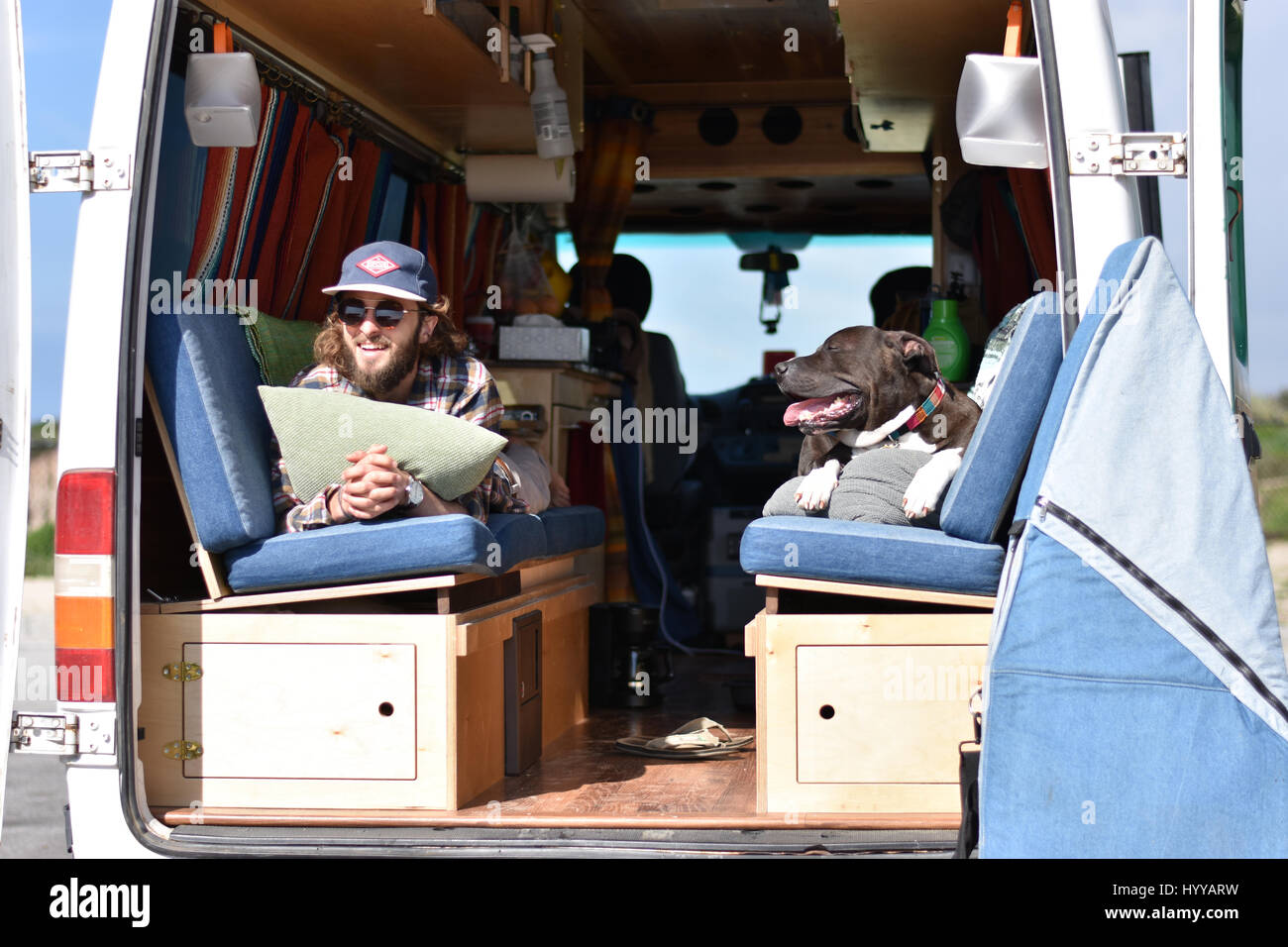MEET the couple who shunned traditional office jobs and spent $5,000 converting their Dodge Sprinter van into a home to live life on the road with their beloved pet dog. The series of envy inducing pictures and video show Pete Thuli (24) and Taylor Bucher (23) also known as Always the Road from Wisconsin, USA enjoying life on the road as they travel around the states of America with their American Staffordshire Terrier, Snoop. Other shots show how the couple worked for four months whilst both holding down full time jobs to refurbish the van’s shell into a fully functional home complete with ki Stock Photo
