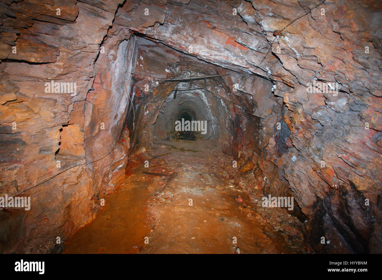 CALLINGTON, CORNWALL, UK: EERIE images reveal the Cornish mining tunnel that was once used to test explosives and research the potential impact of nuclear tests during the Cold War under the code name Operation Orpheus. The haunting pictures show inside the 2,180-foot tunnel where rusting sleepers and collapsing structures remain. Other shots, look down into an adit (entrance) and show the unsuspecting exterior of the mine where a metal gate has been closed across. The spectacular images were taken at the Excelsior Tunnel, Kit Hill, Callington, Cornwall by editor, Nat W (46) from London. To ta Stock Photo