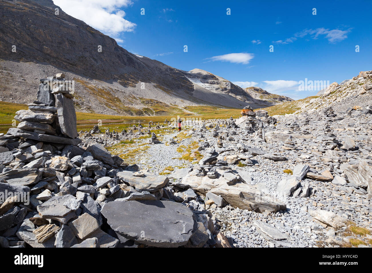 Stones and path signals on hiking trail near Vanoise torrent. Hikers. Parc National de la Vanoise. France. Europe. Stock Photo