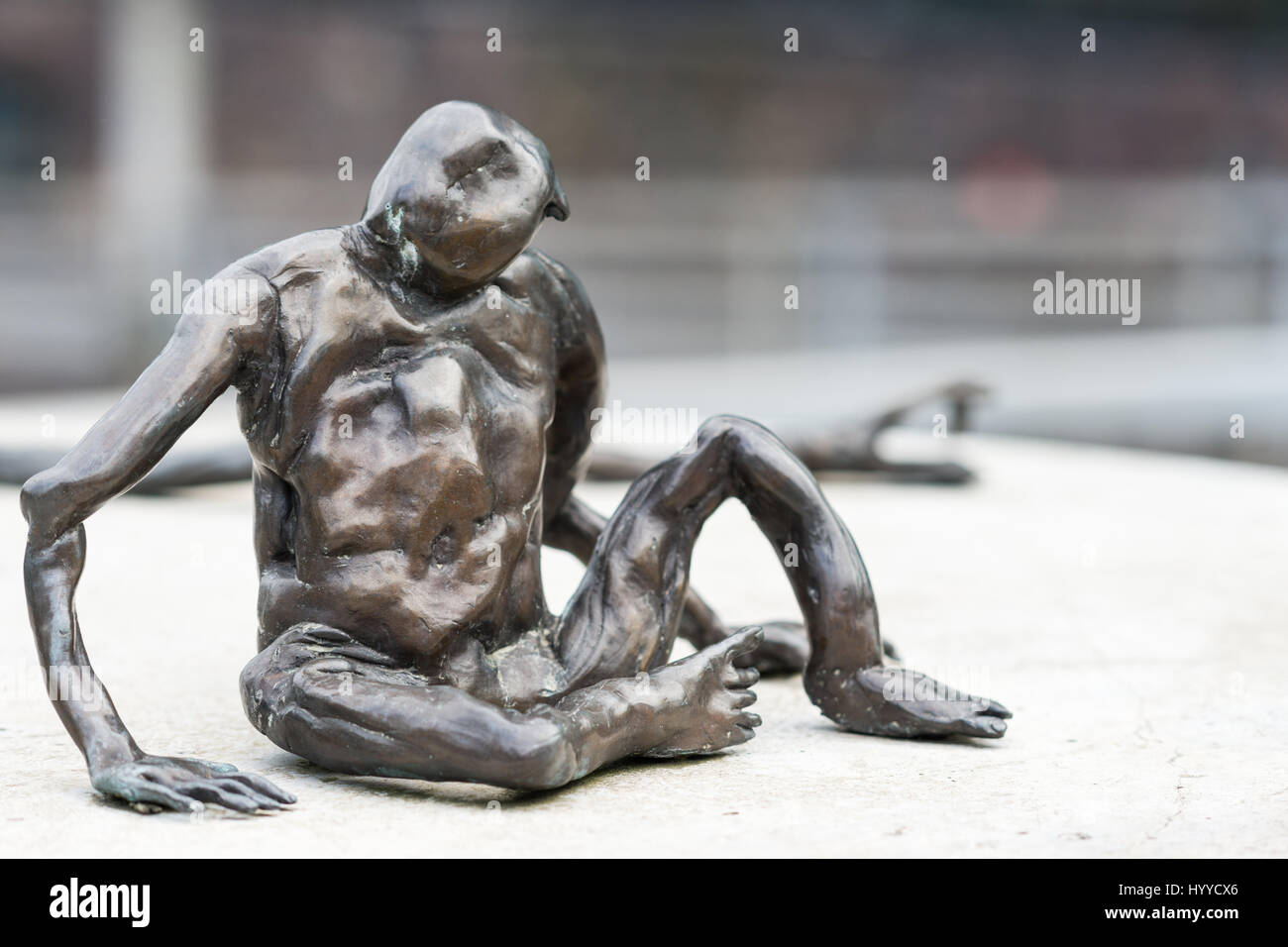 Auckland, New Zealand - March 1, 2017: Overpass Symonds and Wellesley streets. One of public tiny bronze statues, called Loafer, created by Francis Up Stock Photo