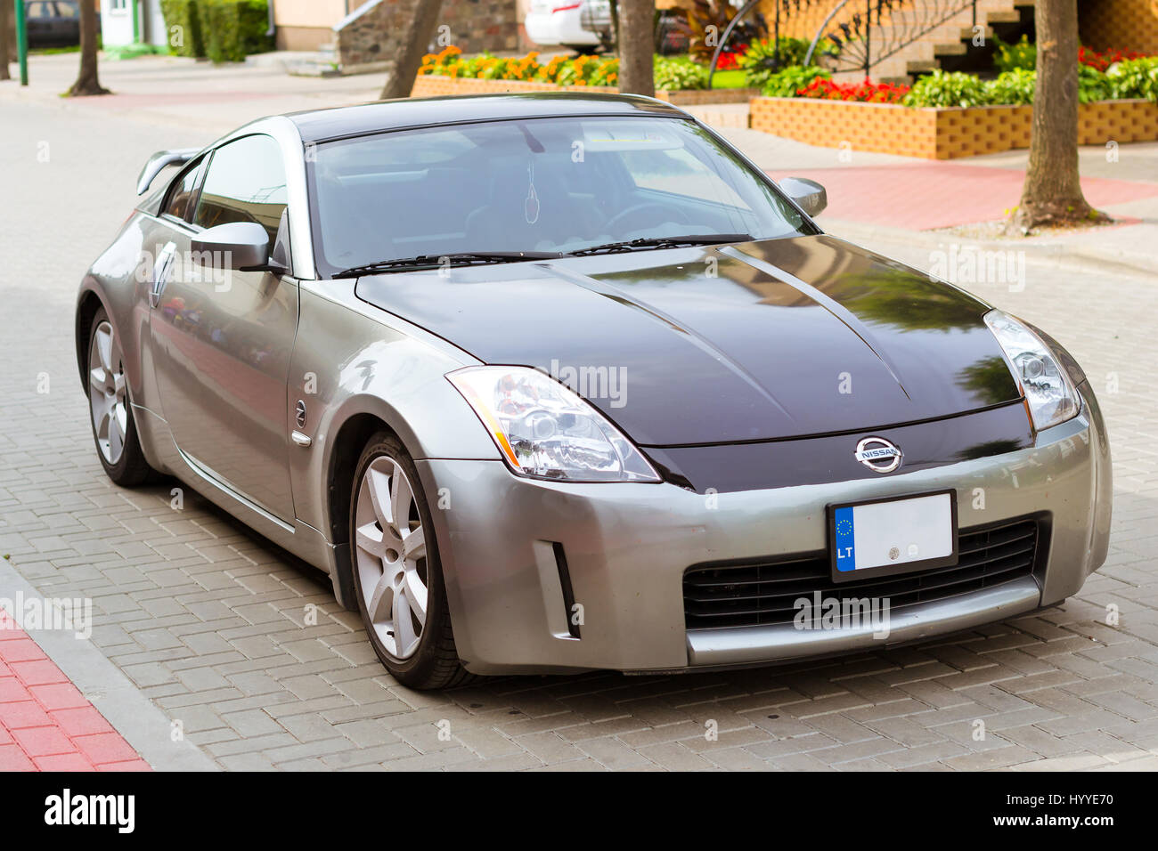 Palanga, Lithuania - August 13, 2012: Modern sports coupe car Nissan 350z parked on main transport highway in Lithuanian resort town Palanga. Youth hi Stock Photo