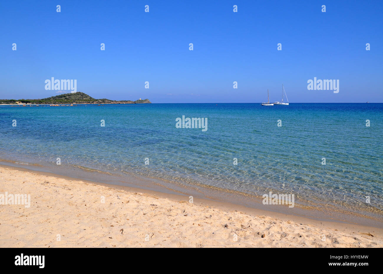 white sailing boats in the mediterranean sea at Nora beach on Sardinia island in Italy Stock Photo