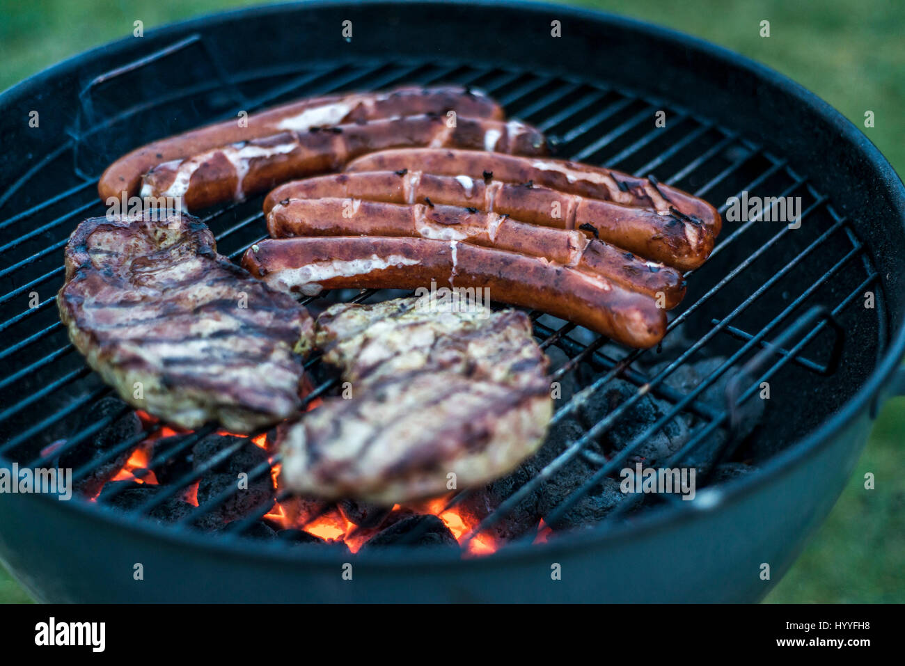 tasty delicious grilled meat over coal on barbecue grill bbq Stock