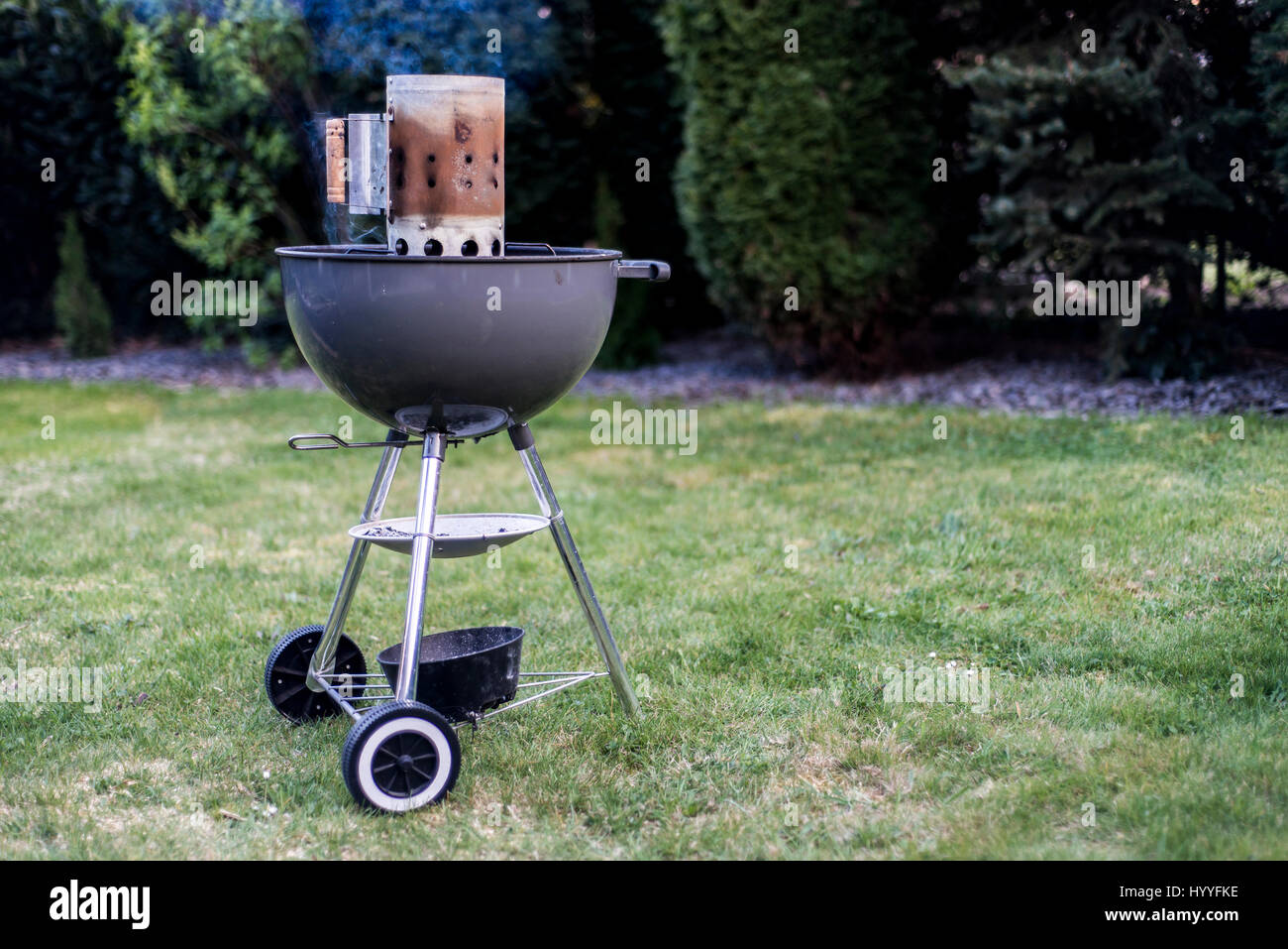 kettle barbecue charcoal grill for roasting BBQ standing on gras ready