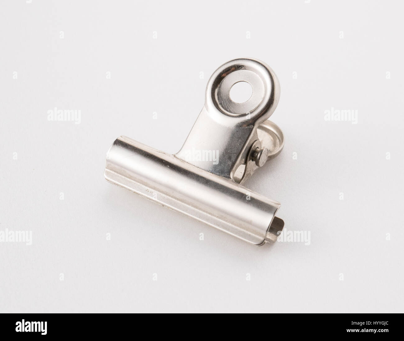 A metal paperclip on a white background. Stock Photo