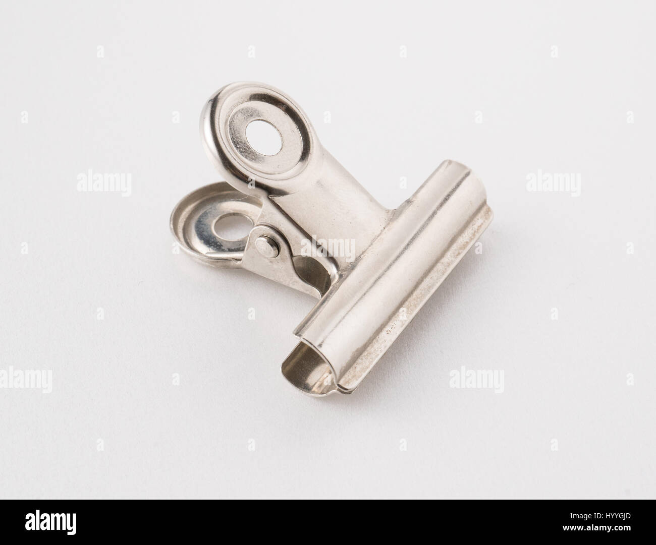 A metal paperclip on a white background. Stock Photo