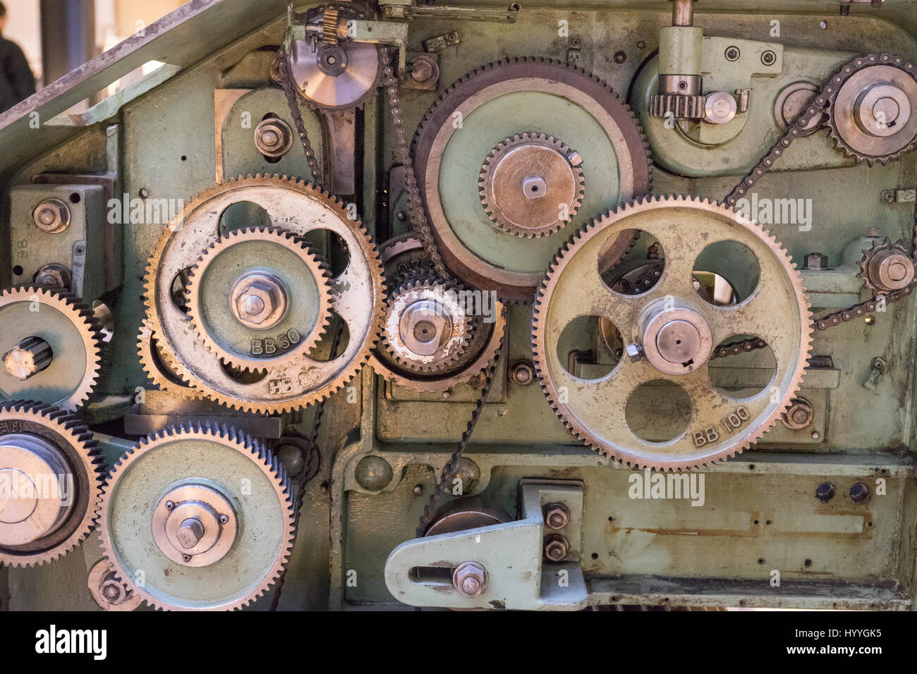 Cogs and gears inside of a vintage textile machine used to produce wool and silk products. Stock Photo
