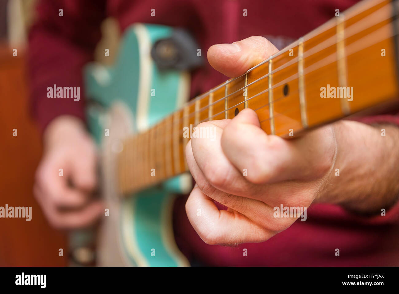 Young Man Playing Electric Guitar Stock Photo