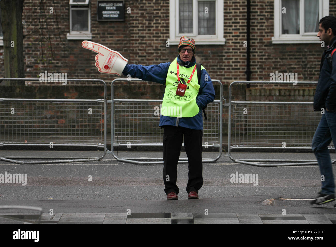 London, UK 24 April 2016. A marshall directs runners for the annual Virgin Money London Marathon at Greenwich on 24th April 2016. Three quarters of all London Marathon competitors run for a charity, the NSPCC being the Official charity of the 2016 marathon.Approximately 38,000 runners are expected to start the run, with the London Marathon’s one millionth finisher crosing the line during this years race, a milestone in the history of the race that started in 1981. © David Mbiyu/Alamy Live News Stock Photo
