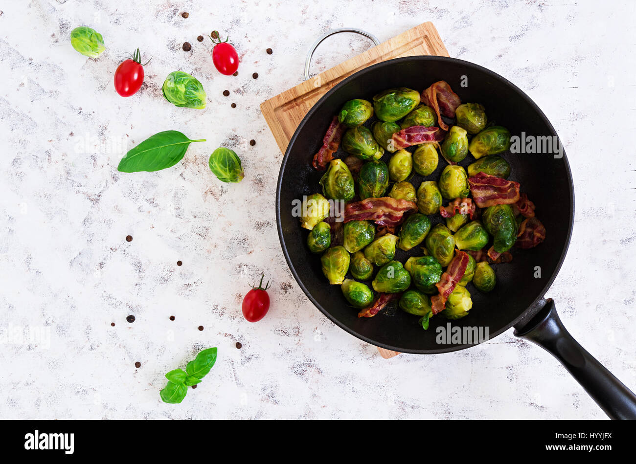 Roasted brussels sprouts with bacon on white background. Top view Stock Photo