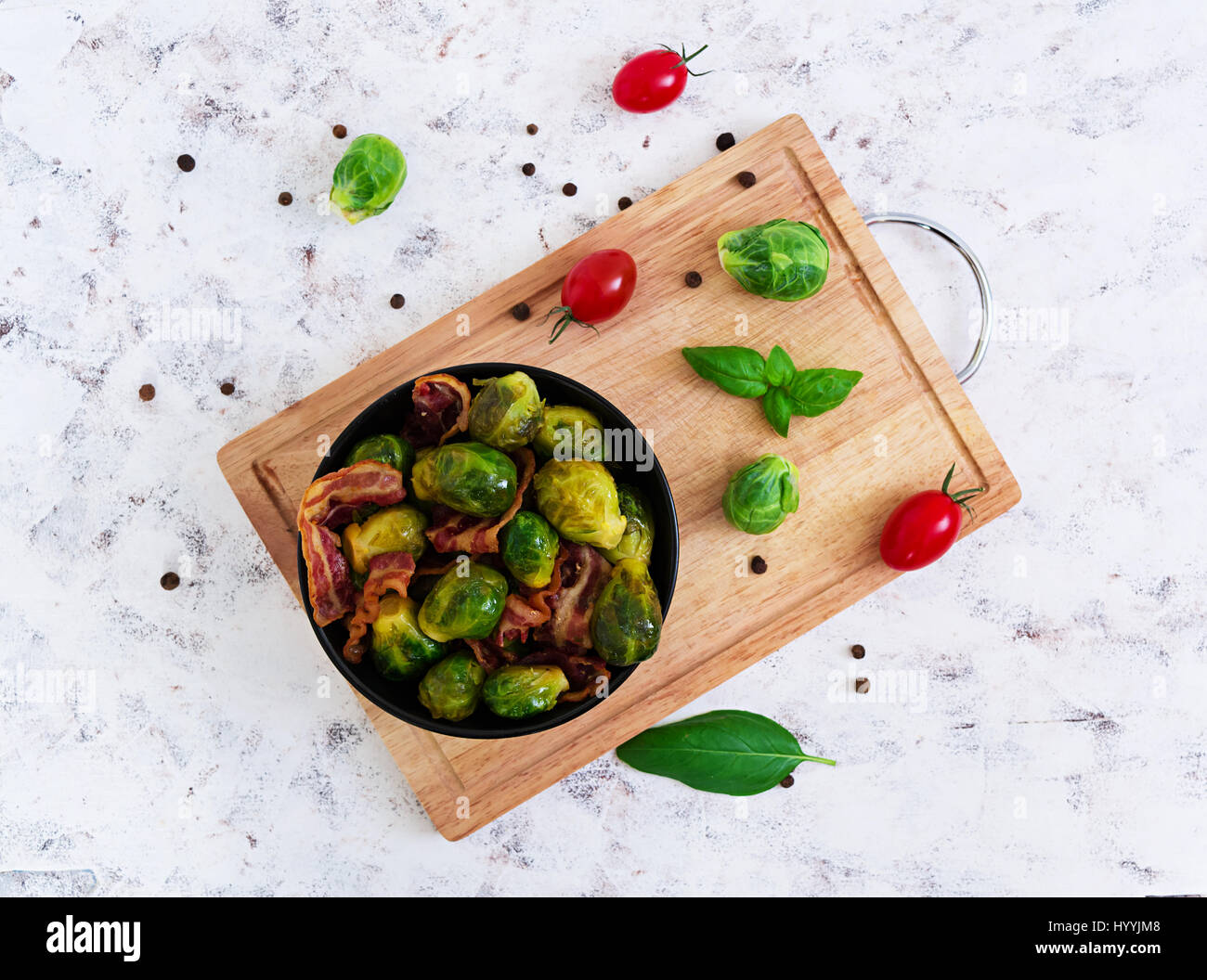Roasted brussels sprouts with bacon on white background. Top view Stock Photo
