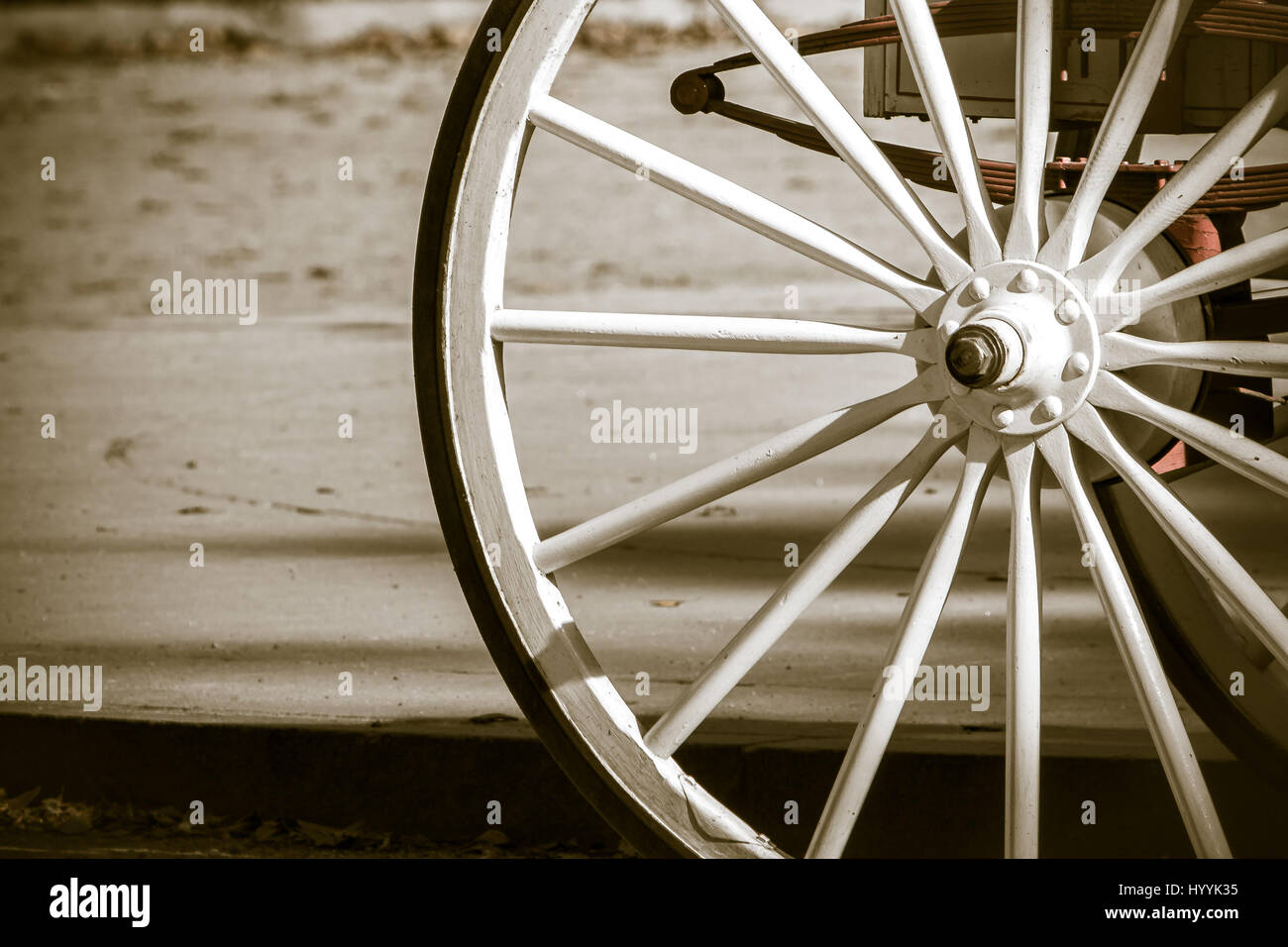 Wooden wheel of a horse drawn carriage. Stock Photo