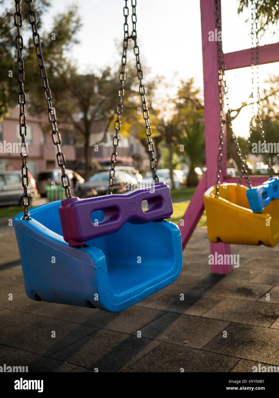 Colorful swing set at a playground in a park Stock Photo - Alamy