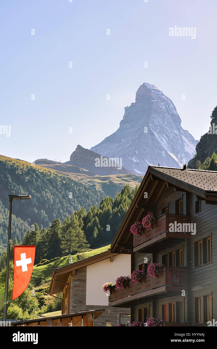 Traditional Chalet in Zermatt with Matterhorn peak with Swiss flag ...
