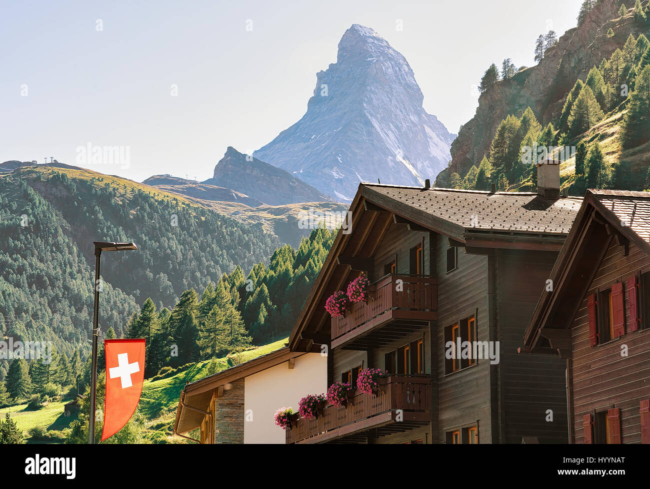Traditional Chalets in Zermatt with Matterhorn peak with Swiss flag ...