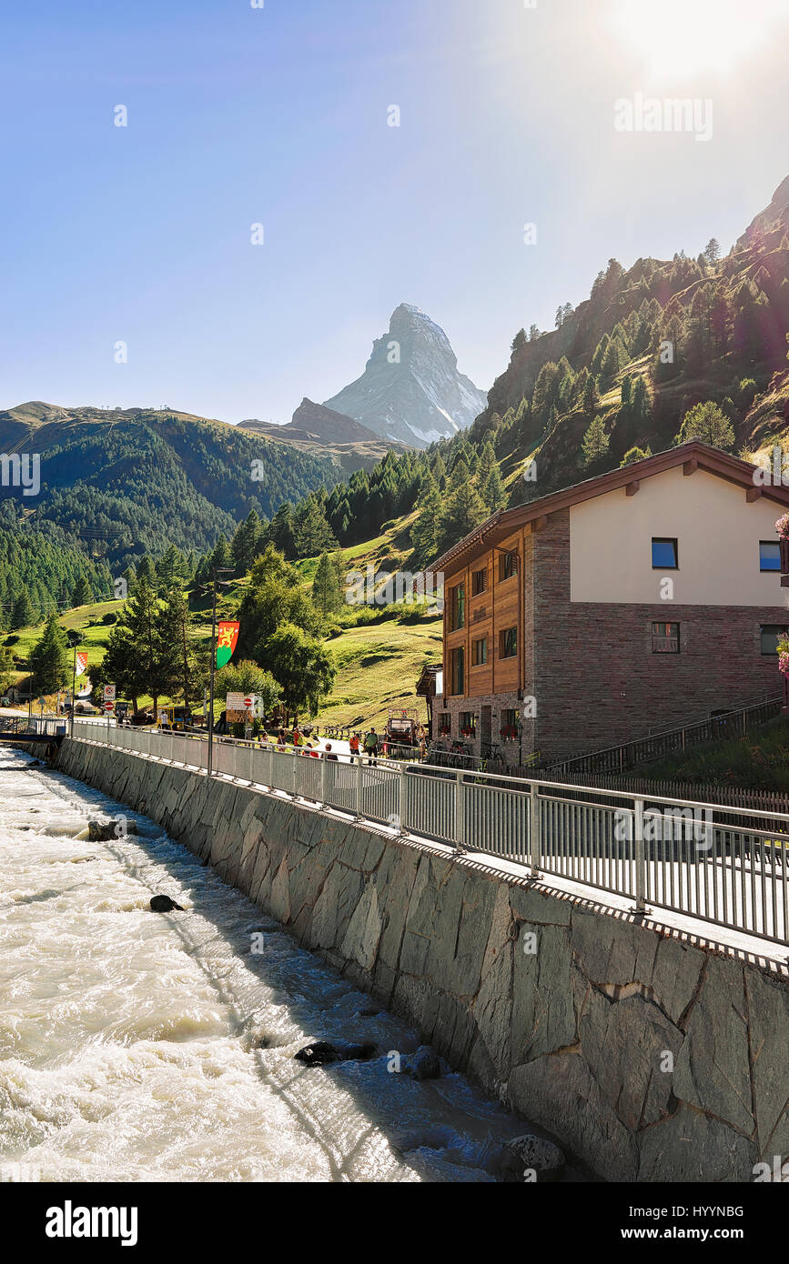 Traditional Swiss chalets and Gornera River in resort city Zermatt with ...