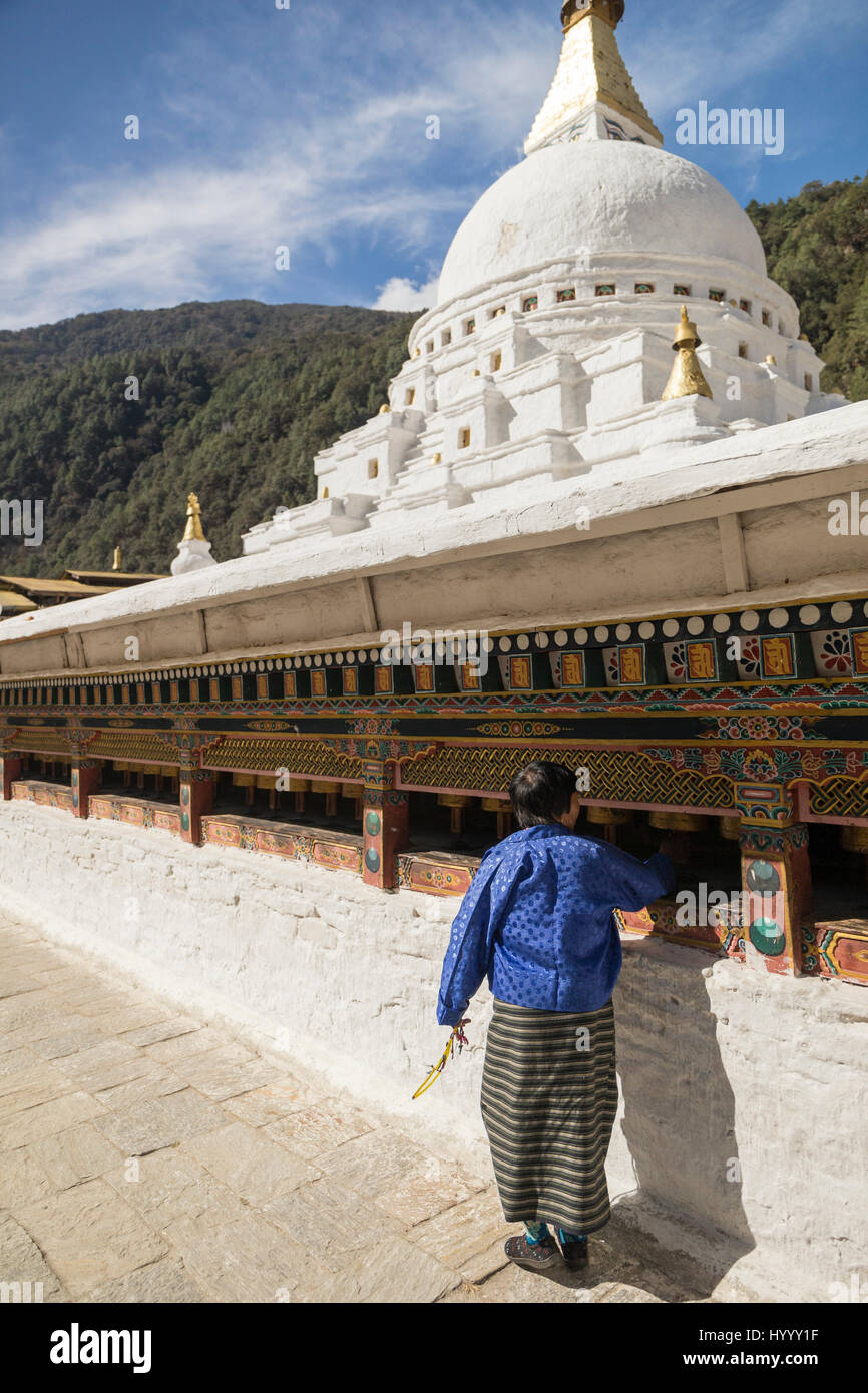 Bhutanese woman turning prayer wheels (Bhutan) Stock Photo