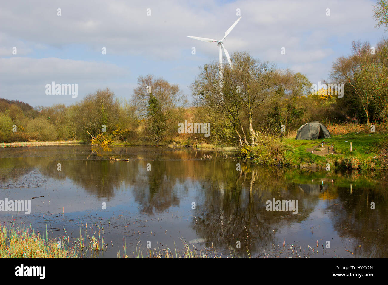 A two man tent pitched on a piece of ground beside the lake at the old lead mines workings in Conlig, County Down in N Ireland on an early spring day. Stock Photo