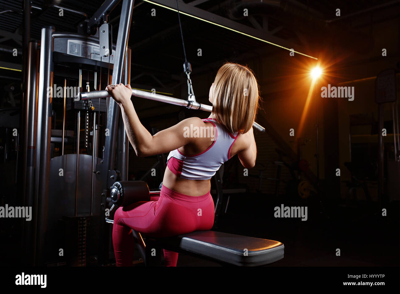 Young fitness woman doing exercises the major muscle groups in the gym. Strength training Stock Photo