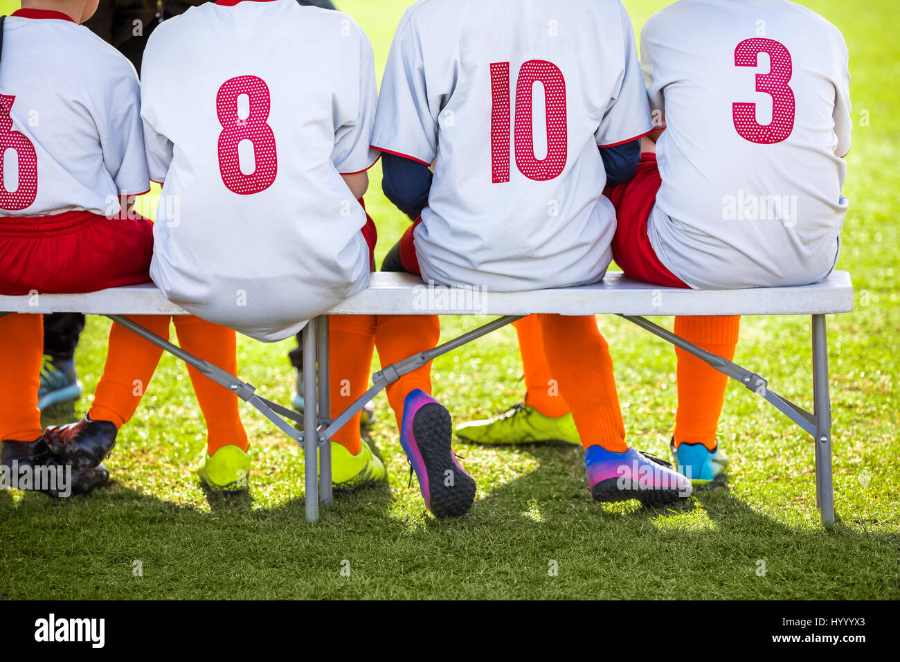 Soccer team kids sitting on the bench 