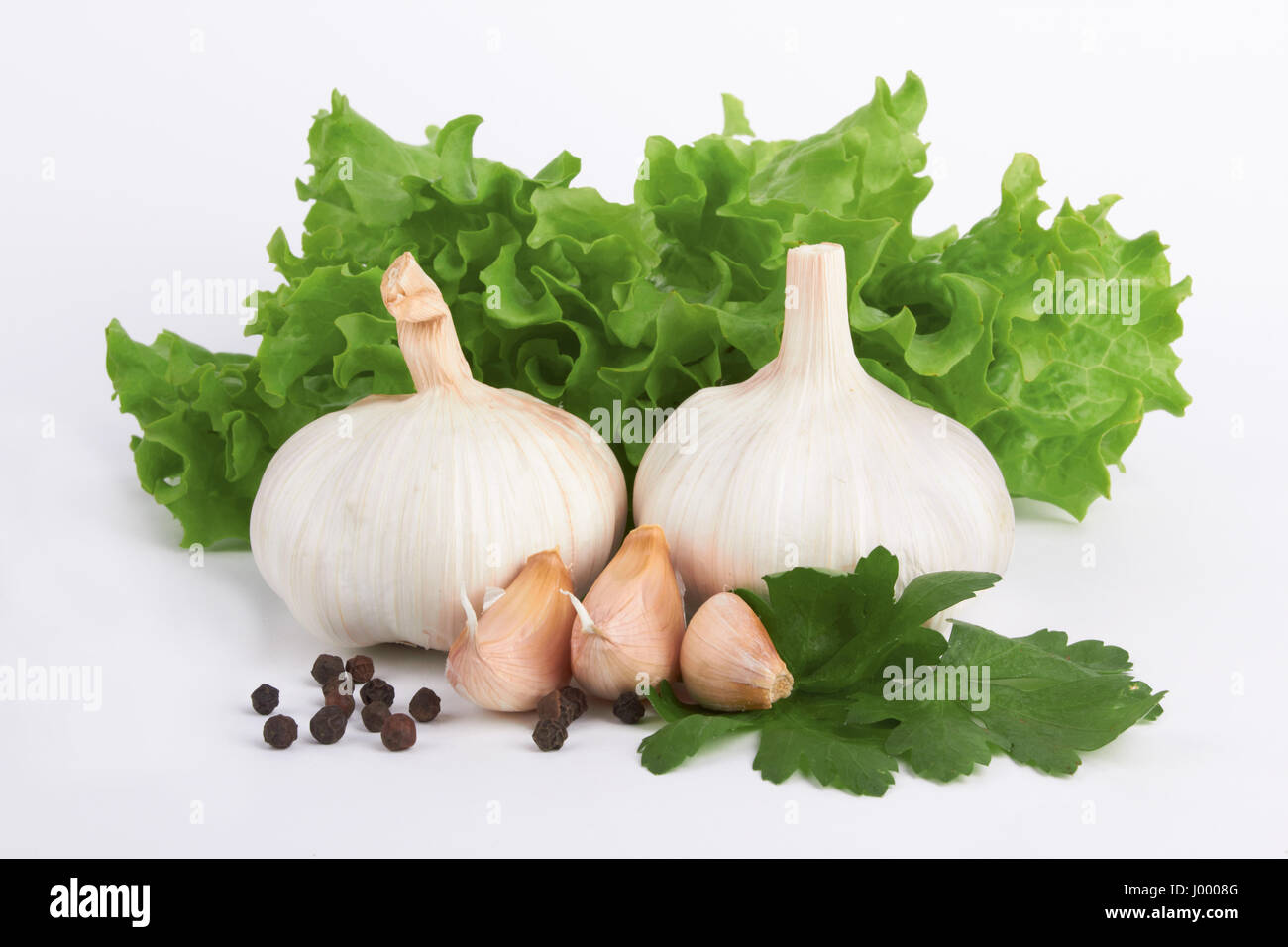 garlic decorated parsley leaves on white background Stock Photo - Alamy