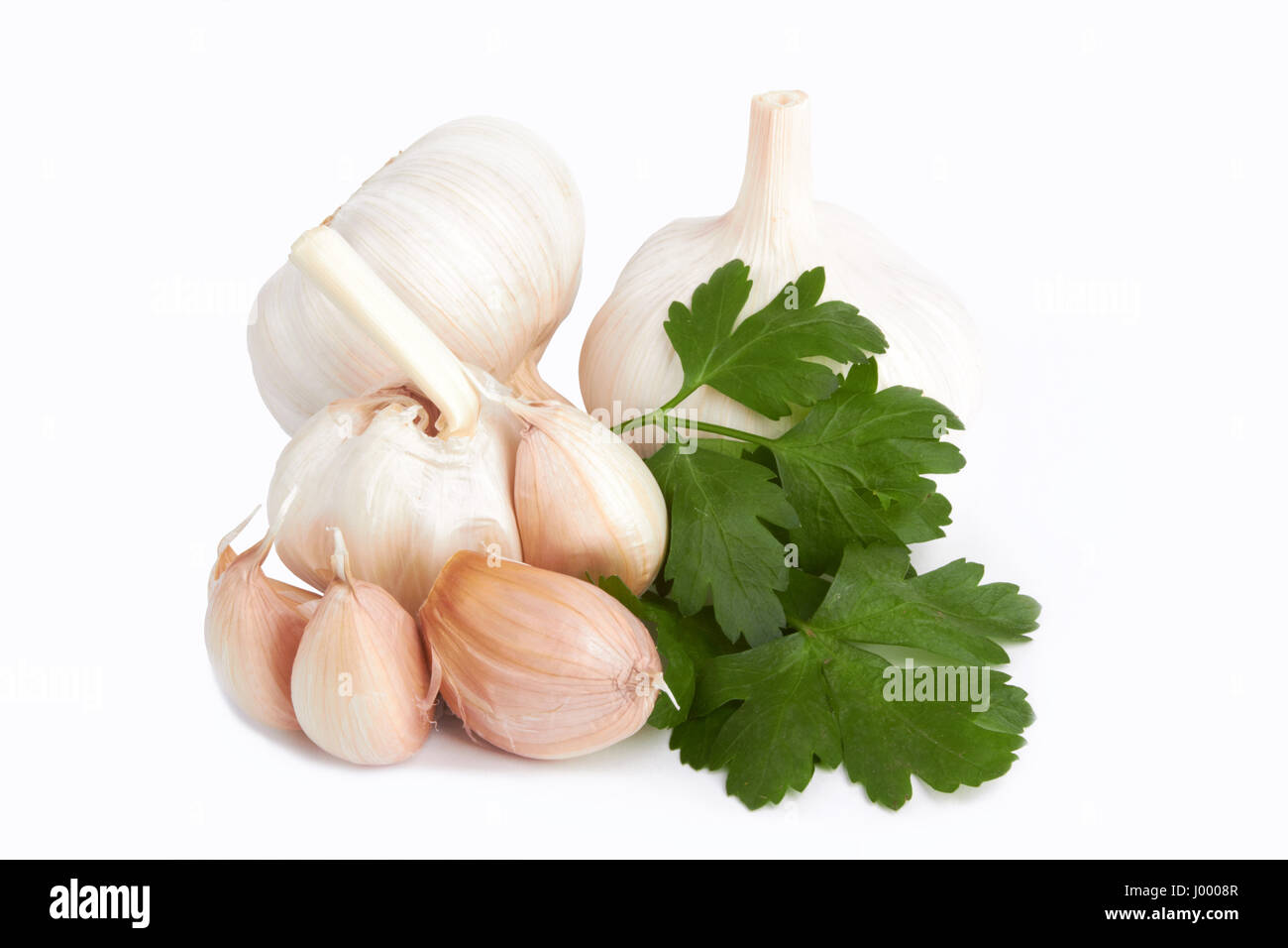 garlic decorated parsley leaves on white background Stock Photo - Alamy