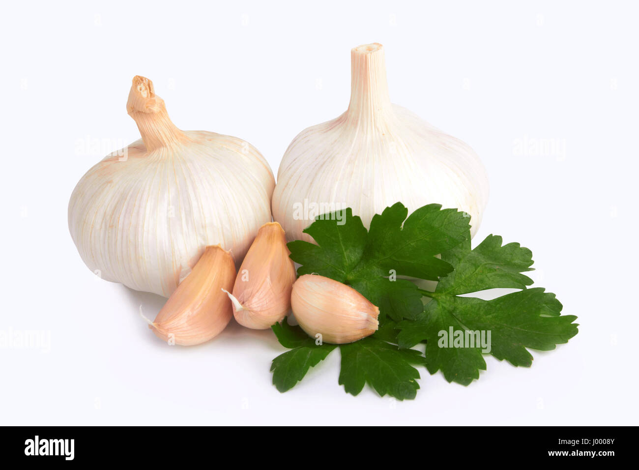 garlic decorated parsley leaves on white background Stock Photo - Alamy