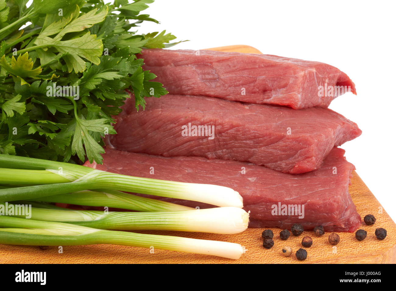 fresh raw beef meat slices over a wooden board Stock Photo