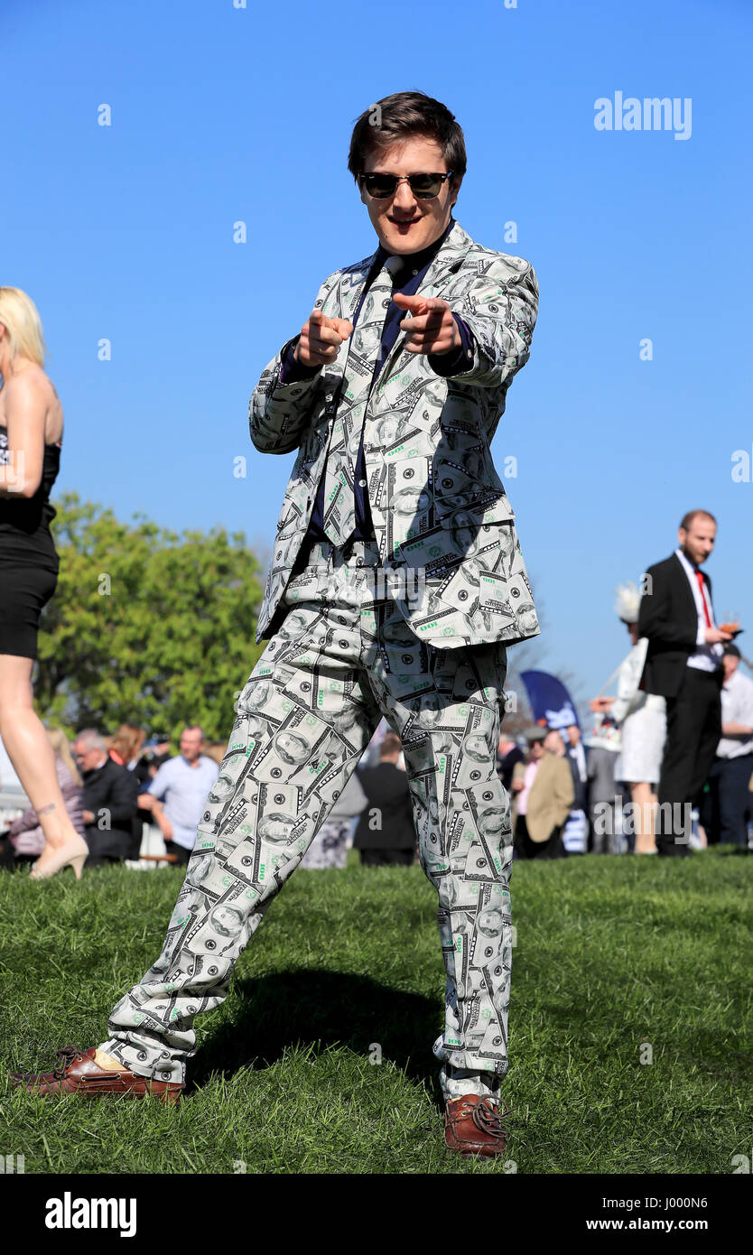 A racegoer wearing a suit with a dollar pattern poses on Grand National ...