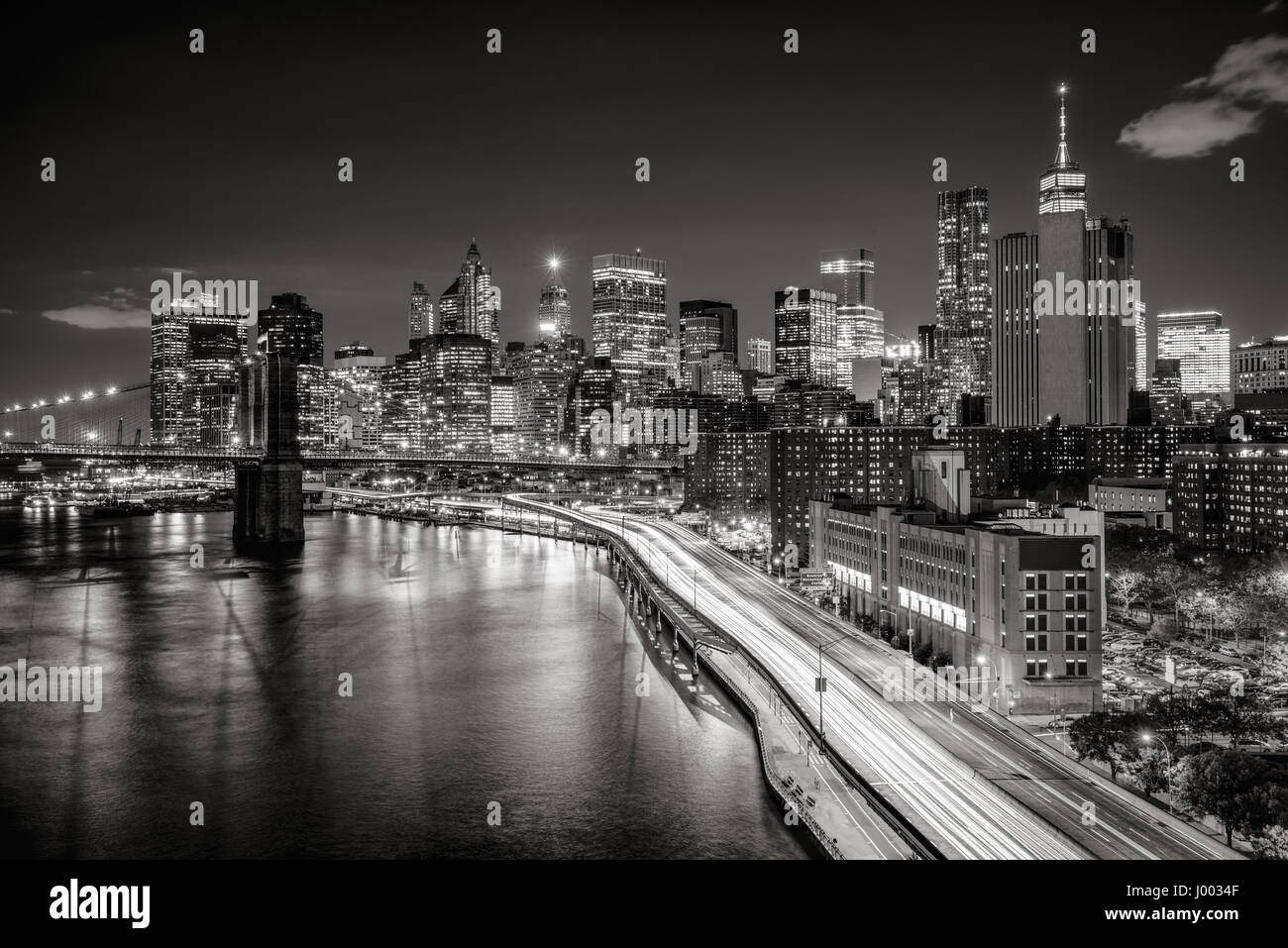 Elevated view of Lower Manhattan skyscrapers and Financial District. The Black & White night view includes the West tower of the Brooklyn Bridge, East Stock Photo