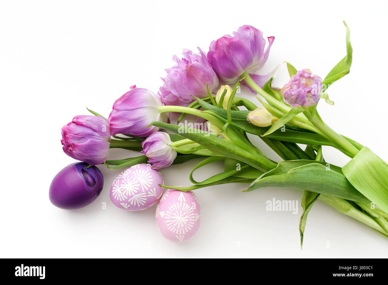 Easter eggs and tulips on white background. Flat lay. Top view Stock ...