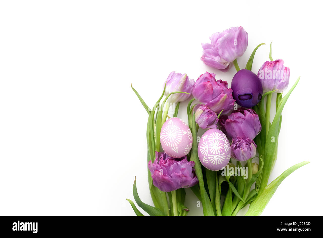 Easter eggs and tulips on white background. Flat lay. Top view Stock ...