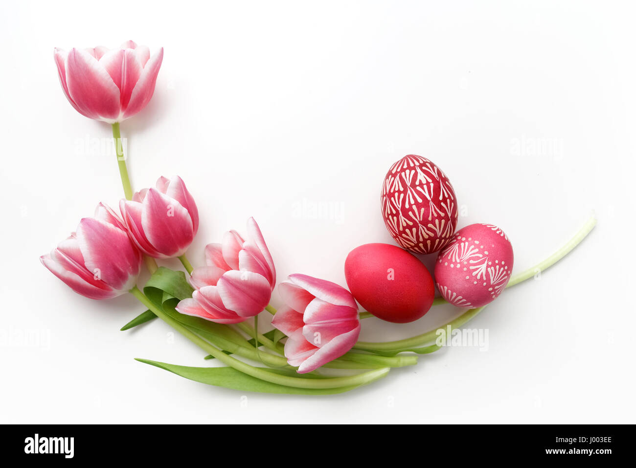 Easter eggs and tulips on white background. Flat lay. Top view Stock ...
