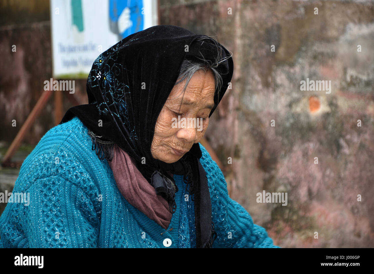 NINH BINH,VIETNAM - FEBRUARY 21, 2013: Elderly Vietnamese woman with a scarf living in the rural areas of Ninh Binh, Vietnam Stock Photo