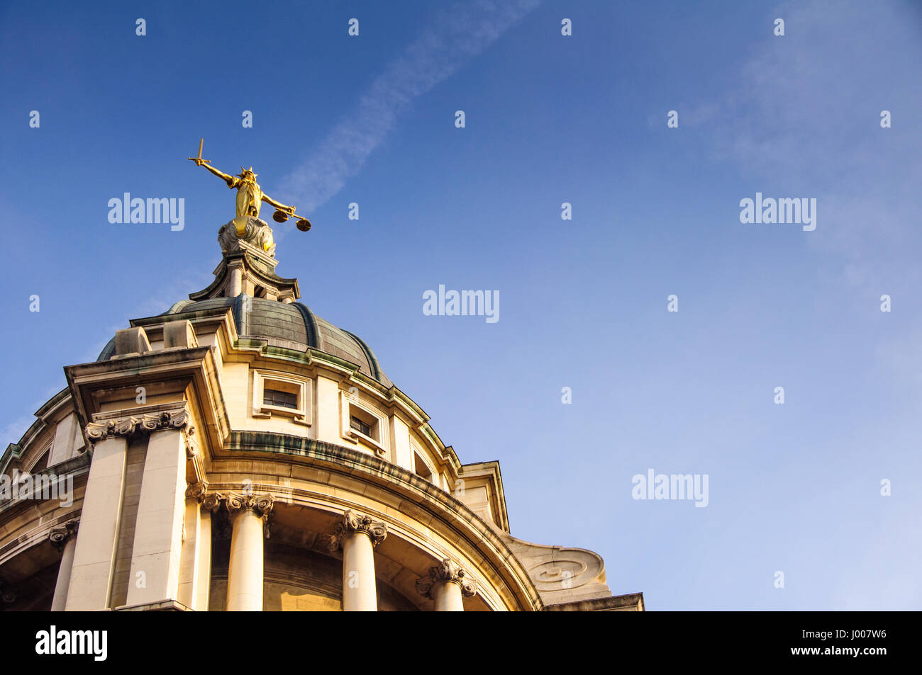 London, England - March 20, 2009: A statue of Justice stands over England's Central Criminal Court on London's Old Bailey. Stock Photo