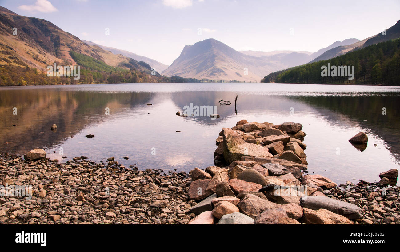 The mountains of Fleetwith Pike and Giant Haystacks rise above the lake at Buttermere in England's Lake District. Stock Photo