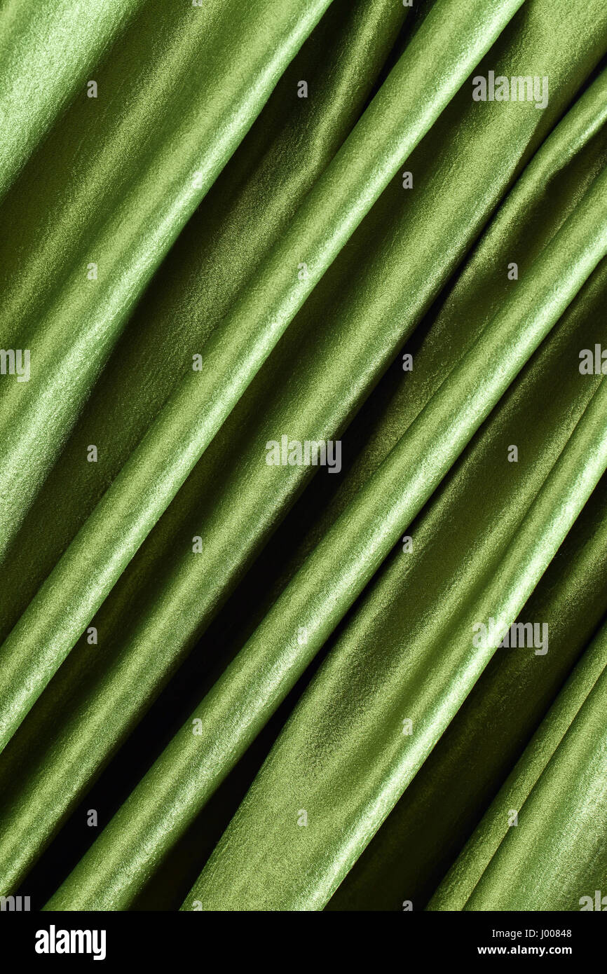 Smooth elegant green satin or silk .Cloth texture can use as background ...