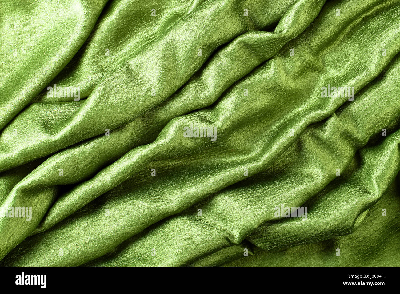 Smooth elegant green satin or silk .Cloth texture can use as background